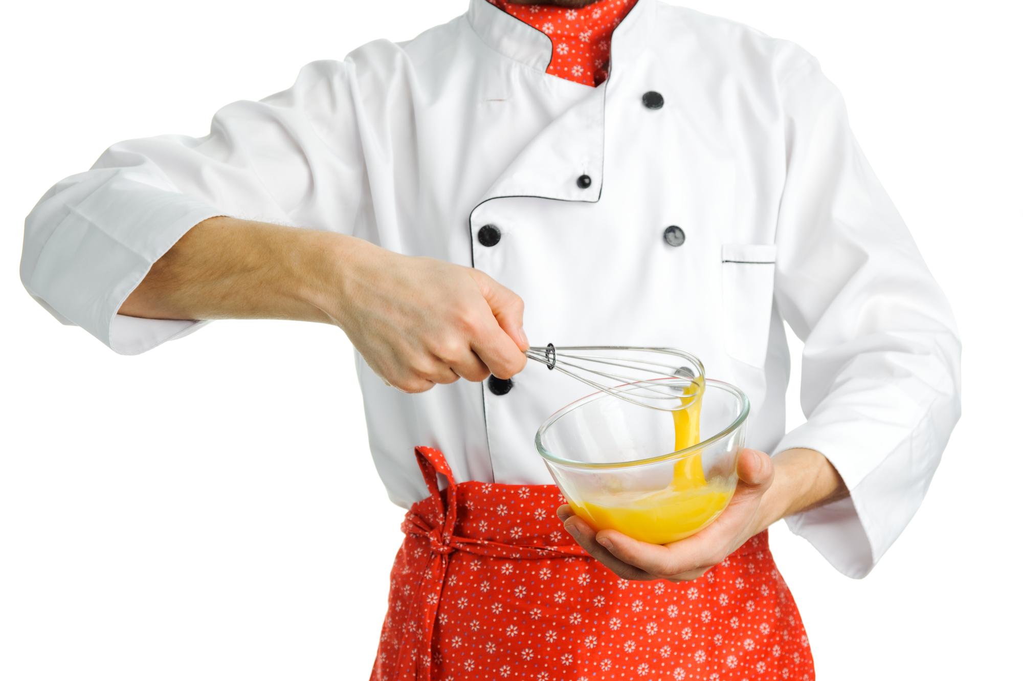 Smiling pastry chef preparing dessert